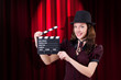 Woman gangster with movie clapper