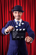 Man with movie clapper on curtain background