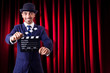 Man with movie clapper on curtain background