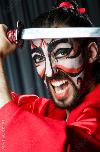 Photo: Man with sword and face mask Man with sword and face mask