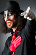 Joker personification with man in dark room
