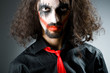 Joker personification with man in dark room
