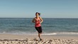 Cheerful brunette working out on the beach
