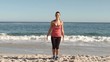 Happy woman working out on the beach