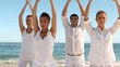Group of people practicing yoga on the beach