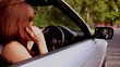 Woman in a silver car