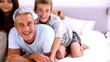 Family saying hello on a bed