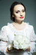 Studio portrait of bride in old-fashioned white dress