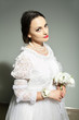 Studio portrait of bride in old-fashioned white dress