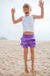 Young girl jumping in sand