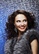 Fashion Model with Shiny Earrings in Fur Vest. Toothy Smile