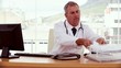 Doctor searching document and using his computer