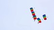 Group of paragliders performing aerobatics.