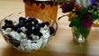 Blueberries stirred with a spoon with cottage cheese