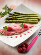 Photo: sole fish with raspberry cream and asparagus, selective focus sole fish with raspberry cream and asparagus, selective focus