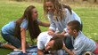 Happy family playing together in a park