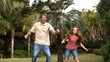 Video: Smiling daughter jumping on a trampoline with her father Smiling daughter jumping on a trampoline with her father