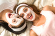 Photo: Crazy girls with facial mask lying bed Crazy girls with facial mask lying bed