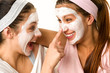 Photo: Playful teen wearing mask touches friend's nose Playful teen wearing mask touches friend's nose