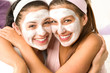 Photo: Blissful girls applying mask hugging each other Blissful girls applying mask hugging each other