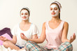 Photo: Meditating women wearing white facial mask Meditating women wearing white facial mask