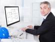 Mature Architect Male Working At The Desk