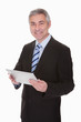Mature Businessman Holding Dig...