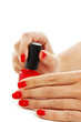 Manicure. applying red nail polish