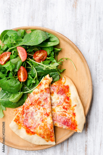 Photo: Slices of pizza with side salad Slices of pizza with side salad