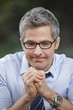 Businessman thinking with his hands clasped