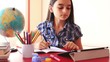 Teenage girl doing homework on tablet pc
