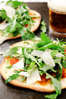 Thin crust individual pizzas flatbread with wild rocket
