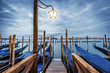 Foto: Gondolas in lagoon of Venice on sunset Gondolas in lagoon of Venice on sunset