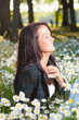 Beutiful smiling happy woman on field of flowers