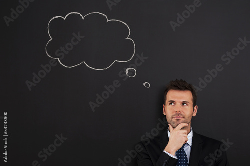 Photo: Portrait of pensive and thoughtful businessman Portrait of pensive and thoughtful businessman