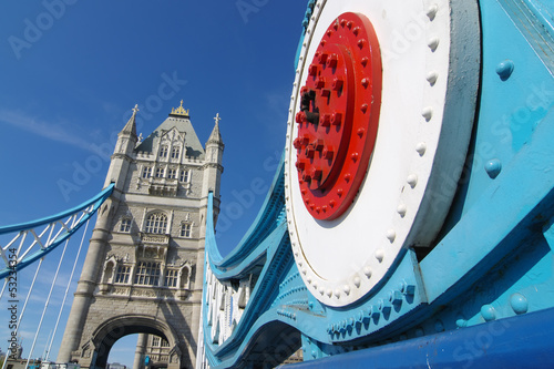 Tower Bridge in London and detail suspension joint. The bridge's present colour scheme dates from 1977, when it was painted red, white and blue for the Queen Elizabeth II's silver jubilee