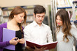 Three friends in a library