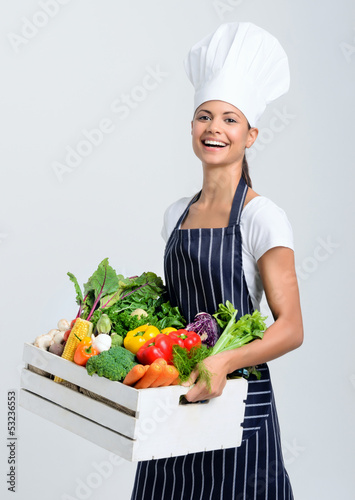 Photo: Chef with box full of raw vegetables Chef with box full of raw vegetables