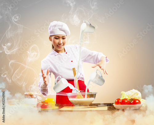 Photo: Asian female cooking with magic Asian female cooking with magic