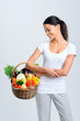 Woman with raw fresh produce in a basket