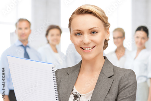 Photo: happy woman with big notepad happy woman with big notepad
