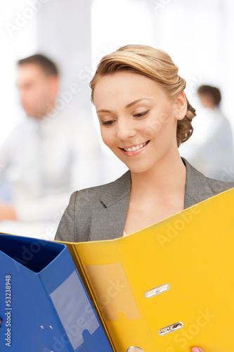 Photo: young attractive businesswoman with folders young attractive businesswoman with folders