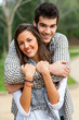 Handsome couple hugging in park.