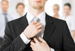 man adjusting his tie