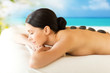woman in spa with hot stones