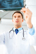 male doctor or dentist looking at x-ray