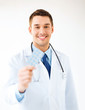 young male doctor with pack of pills