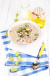 Photo: Useful oatmeal in bowl with fruit on wooden table close-up Useful oatmeal in bowl with fruit on wooden table close-up