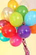 Photo: Many bright balloons on yellow background Many bright balloons on yellow background