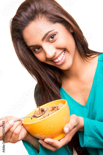 Photo: Beautiful mix race woman eating cereals Beautiful mix race woman eating cereals